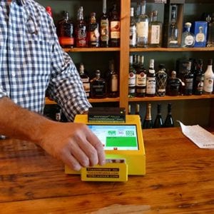 ID scanner on liquor store countertop